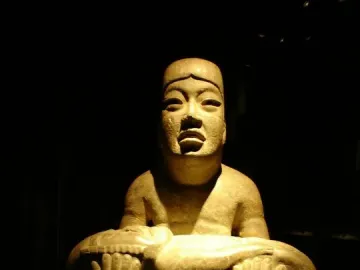 Las Limas figurine showing a cross-legged stone figure holding a smaller figure across its lap.