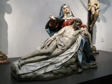 Pietà sculpture of a grieving Mary holding the lifeless body of Jesus across her lap.