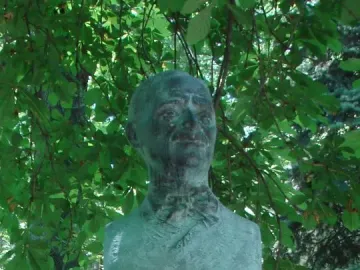 Tudor Arghezi bust on a red granite pedestal in the Alley of Classics