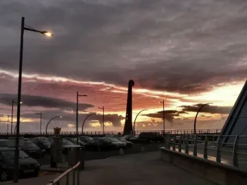 The Blackpool High Tide Organ silhouetted against a dramatic sunset sky on the promenade.