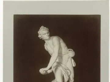 Bernini\'s David marble statue in a dynamic twisting pose, holding a sling and standing on an ornate base.