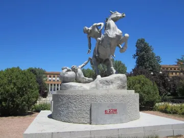 The Torch Bearers sculpture showing a rearing horse with a mounted figure and another figure reaching upward from the base.