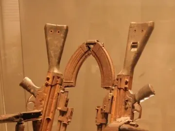 Throne of Weapons sculpture made from rusty gun parts and rifle stocks