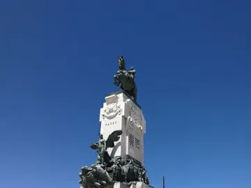 Antonio Maceo Monument with a bronze equestrian statue on a tall stone base decorated with bronze reliefs and figures.