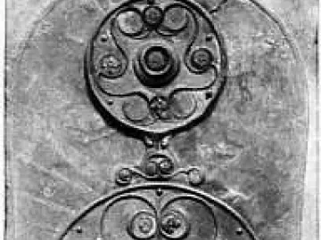 Battersea Shield with three ornate circular bosses and intricate metalwork along its length.