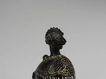 Viterbo Rooster ceramic vessel shaped like a rooster, with etched patterns and inscriptions around its body.