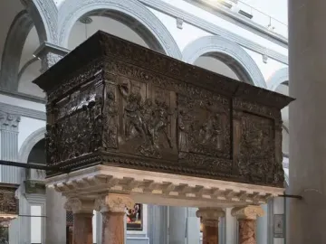 The Passion Pulpit with intricate relief sculptures on a dark rectangular pulpit supported by four marble columns.