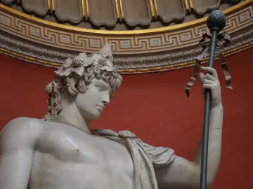 Antinous Braschi marble statue of a youthful male figure wearing a leafy wreath and holding an ornate staff.