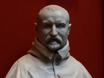 White marble bust of Carlo Antonio del Pozzo with a mustache and pointed beard against a red background.