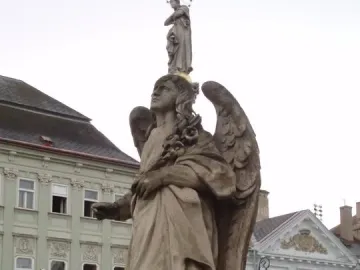 Angel statue on the Immaculata Marian Column with the Virgin Mary above it