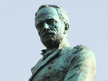 Sherman Monument bronze bust of a bearded man in military uniform against a blue sky