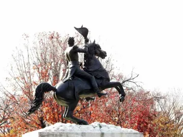 Andrew Jackson equestrian statue with the rider raising a hat overhead on a rearing horse.