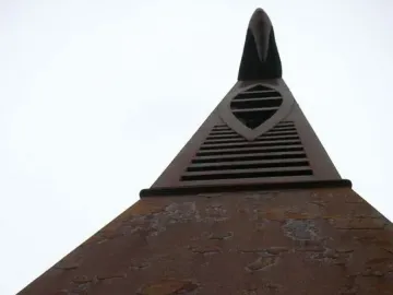 Blackpool High Tide Organ, a tall rust-brown metal sculpture with horizontal vents and an abstract crest at the top.