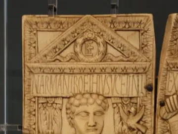 Diptych of Boethius carved ivory panel with a robed figure holding a staff topped by a bird beneath an ornate pediment.