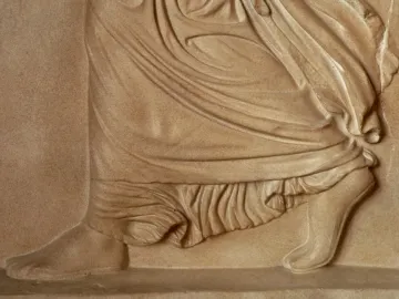 Gradiva relief detail showing the lower body, with one foot planted and the other lifted on its toes.
