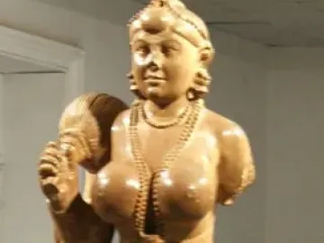 Didarganj Yakshi statue with a crowned female figure holding a fly-whisk and wearing necklaces and a draped skirt