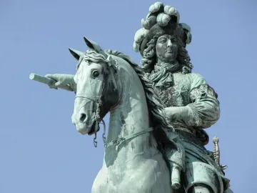 Upper portion of the Equestrian Statue of Louis XIV, showing the rider with a feathered hat and baton on horseback.
