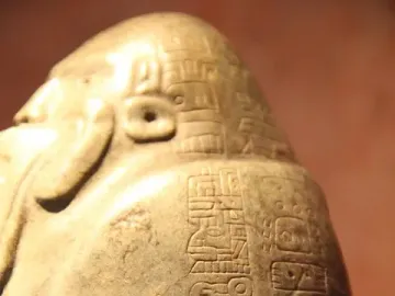 Tuxtla Statuette with carved glyphs and a carved head-like form on its side