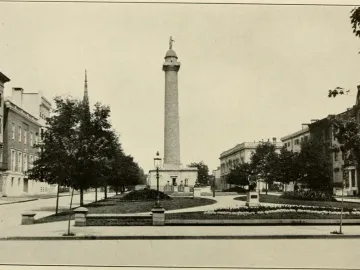 Washington Monument in Baltimore, a tall column topped with a statue in a landscaped city park