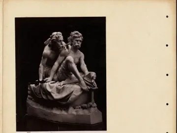 Kanaris at Chios marble sculpture showing two muscular, bare-chested men, one seated with a coiled rope and nautical tool while the other leans over his shoulder