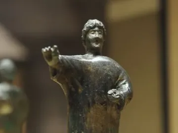 Bronze statuette of the Orator from the Neuvy-en-Sullias Hoard, showing a standing male figure in a tunic with one arm extended and a small object in the other hand.