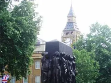 The Monument to the Women of World War II stands in a public square with Big Ben visible in the background.