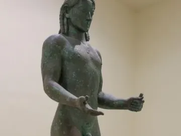 Piraeus Apollo bronze statue of a nude male figure with long hair and outstretched arms