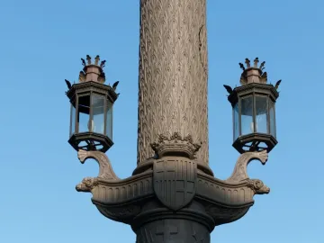Detail of the Galceran Marquet Monument showing a carved column, two lanterns, and decorative ship prows with a crowned shield.