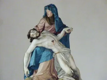 Nenningen Pietà showing a robed woman cradling the lifeless body of a bearded man across her lap.