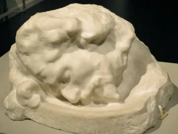 Head of Saint John the Baptist sculpture in white stone, shown resting horizontally in a bowl-like receptacle.