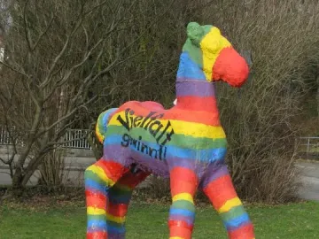 Holbeinpferd concrete foal sculpture painted with rainbow stripes and the text \
