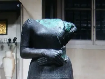 Headless Napir-Asu statue with a decorated skirt and clasped hands