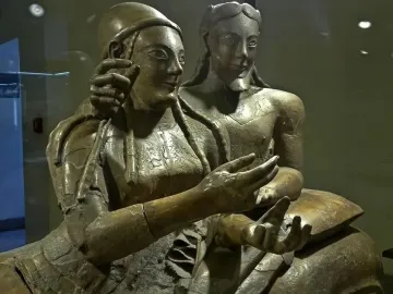 Sarcophagus of the Spouses showing two reclining terracotta figures, a man and a woman, with their arms extended.