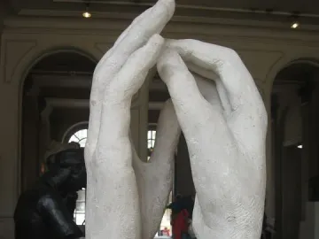 The Cathedral sculpture by Rodin, showing two raised hands forming an arch in a gallery.