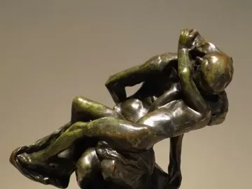 Triumphant Youth bronze sculpture with two intertwined nude figures and a raised, tilted-back pose.