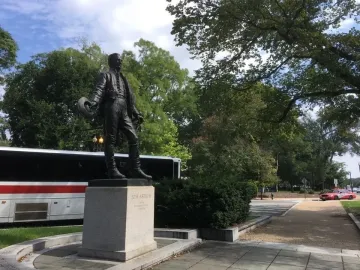 General José Gervasio Artigas statue holding a hat on a stone pedestal.