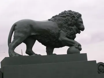 Lions at the Dvortsovaya Pier sculpture of a standing lion with a paw on a sphere.