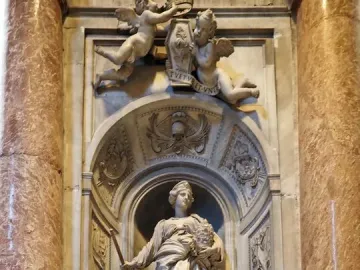 Tomb of Countess Matilda of Tuscany with a standing marble figure in an arched niche, flanked by carved putti and columns.
