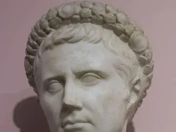White marble bust of Augustus wearing a gemmed crown.