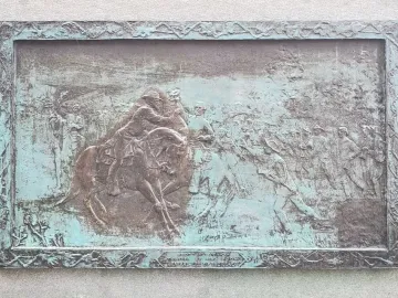 Bronze bas-relief plaque on the John Brown Gordon statue showing mounted soldiers in a battle scene.