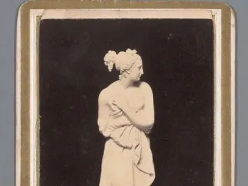 Venus Italica by Canova, a standing female sculpture with arms crossed over her chest and draped fabric.