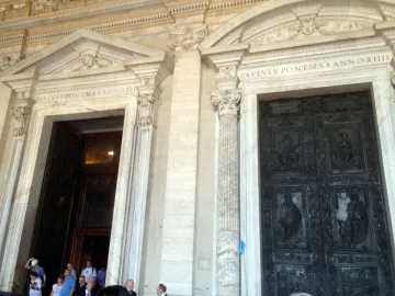 Filarete Door with dark bronze panels depicting figures and scenes on St. Peter\'s Basilica