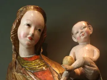 Beautiful Virgin Mary from Krużlowa, a crowned Madonna sculpture in golden robes holding a naked infant and a golden orb.