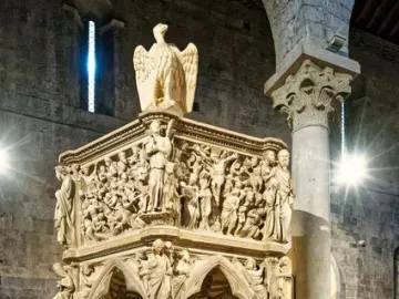 Sant\' Andrea Pulpit with carved marble figures, columns, and animal supports inside a stone church interior
