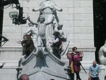 USS Maine National Monument with a camera crane and film crew around the stone sculpture