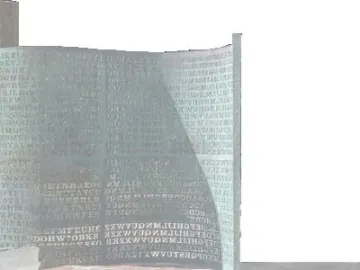 Kryptos sculpture with rows of carved letters and numbers on a greenish-bronze curved surface, partly crossed by shadow.