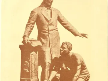 The Emancipation Memorial shows Abraham Lincoln standing with one arm extended beside a kneeling Black man with a broken chain on his wrist.