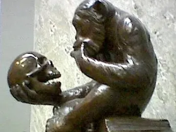 Monkey with a Skull sculpture showing a seated primate holding and gazing at a human skull