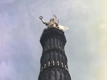 Victory Column seen from below, with a golden winged statue on top of the column.