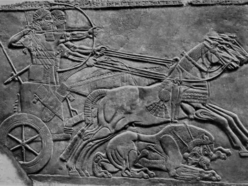Stone relief of the Lion Hunt of Ashurbanipal showing a chariot archer and wounded lions.